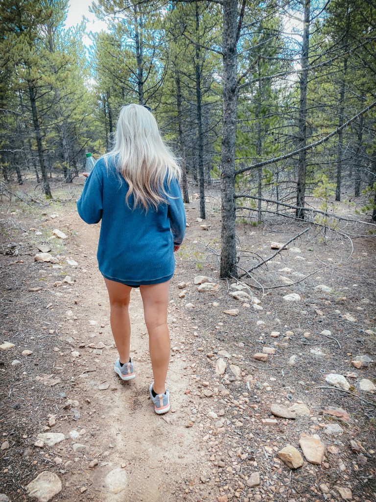 Jeri Walden hiking through the woods.